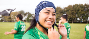 A rugby girl athlete using her headguard