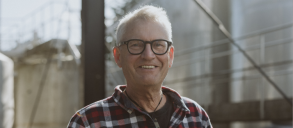 A man smiling to the camera.