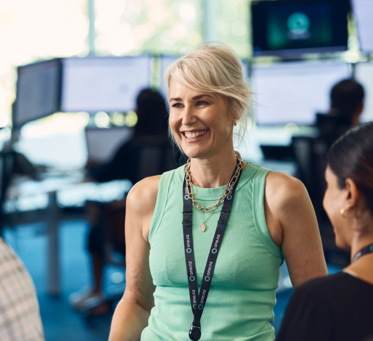A woman smiling to her colleagues.