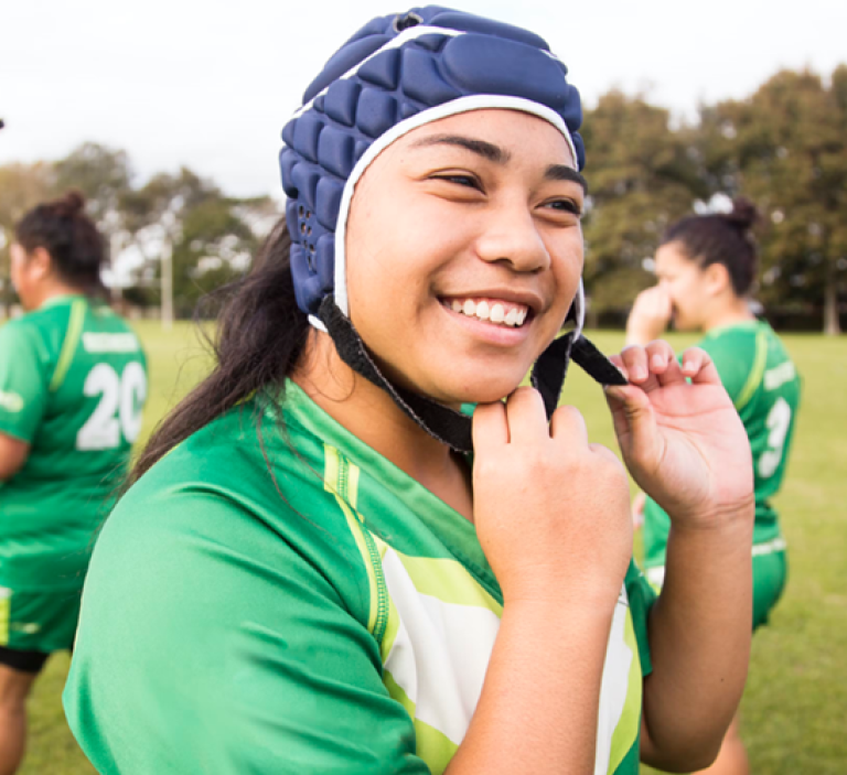 A rugby girl athlete using her headguard
